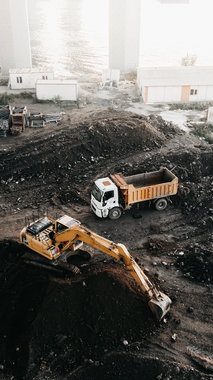 gallery-4 A high angle view of a construction site in Istanbul featuring an excavator and a truck.