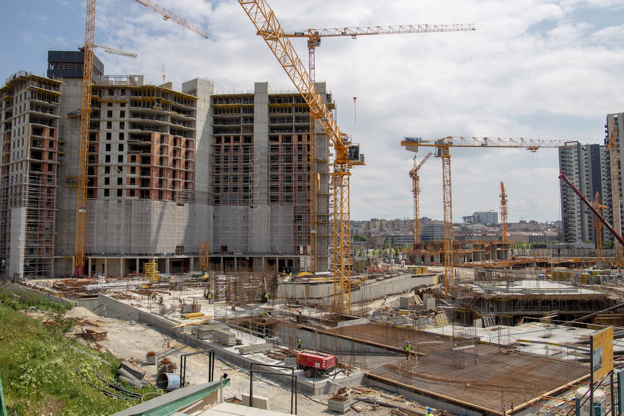 gallery-2 View of a bustling urban construction site with cranes and high-rise buildings.