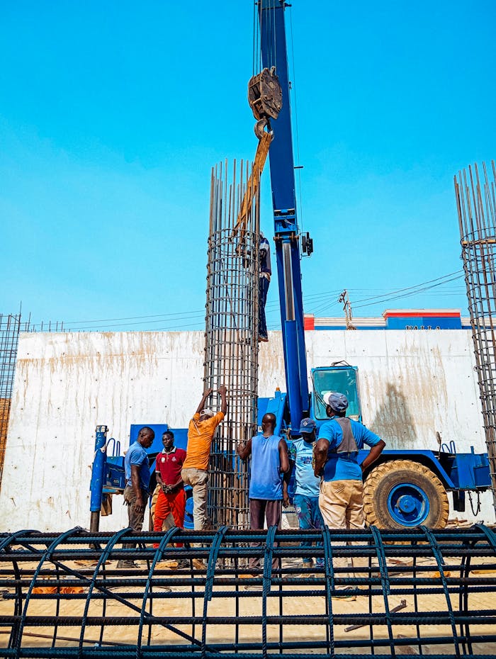 gallery-1 Construction workers in Jimeta, Nigeria erecting rebar columns for a building project.