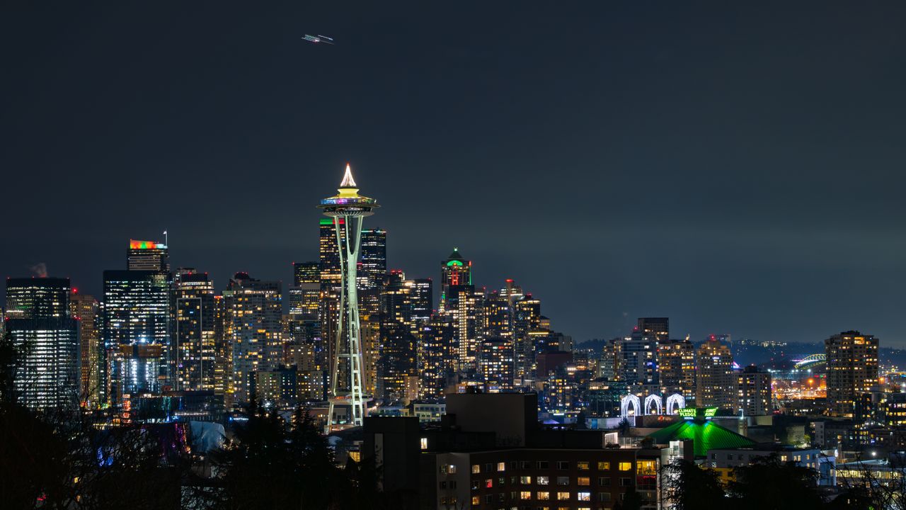 Stunning Seattle skyline at night with iconic Space Needle illuminated against city lights.